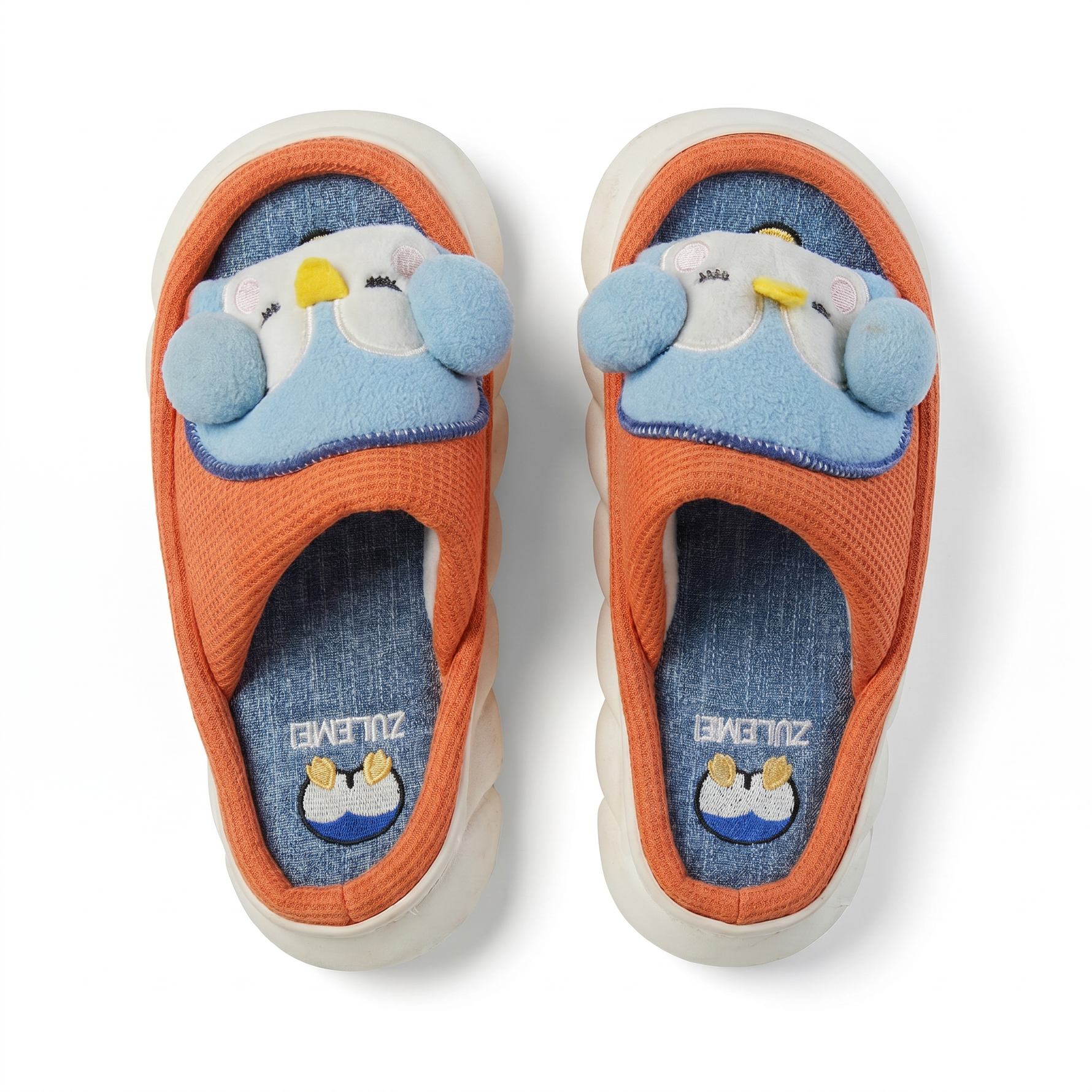 Kids orange and blue slide slippers with penguin character applique